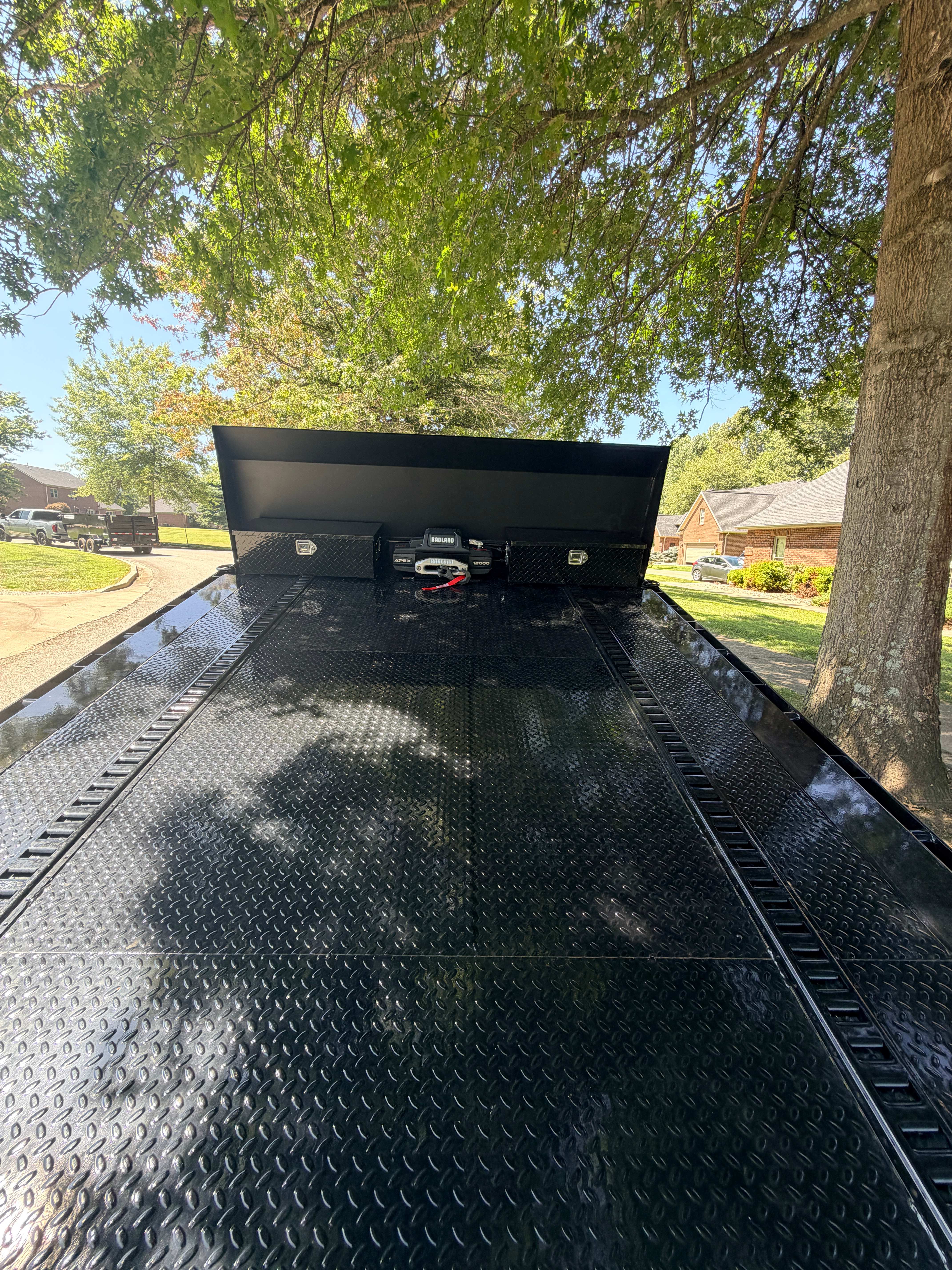 Tilt trailer deck detail - dual diamond plate toolboxes and Badland 12,000lb winch