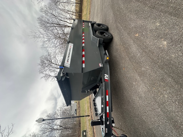 Dump trailer being towed - Heavy-duty construction equipment rental