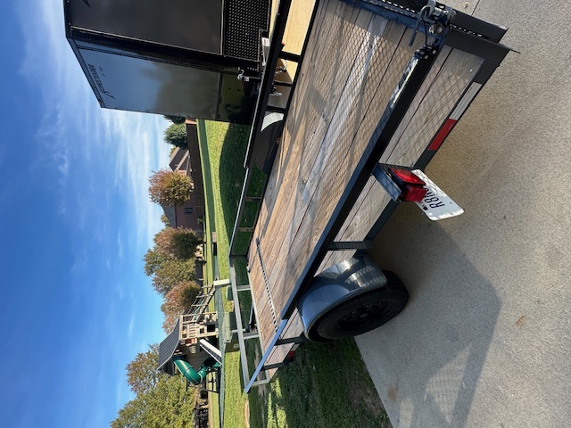 Utility trailer side view - showing treated wood floor and tie-down points